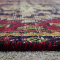 Macro close up of Persian Shiraz rug border showing colorful geometric guard stripes and wool texture