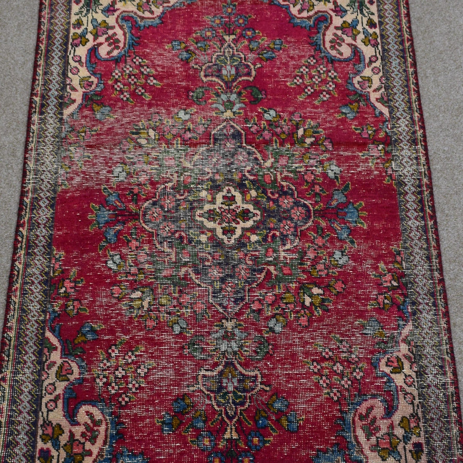Detailed view of vintage Persian Shiraz rug highlighting ornate central medallion and surrounding floral motifs
