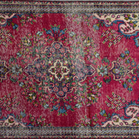 Close up of Persian Shiraz rug medallion showing intricate floral design in ivory, blue and red tones