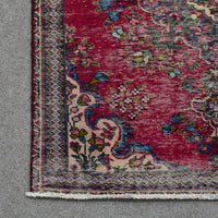 Close up of Persian Shiraz rug border with colorful floral motifs and decorative guard stripes