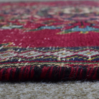 Macro close up of vintage Persian Shiraz rug pile showing wool texture and colorful woven pattern