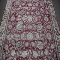 Detailed view of vintage Persian rug pattern featuring faded floral motifs and traditional Persian design