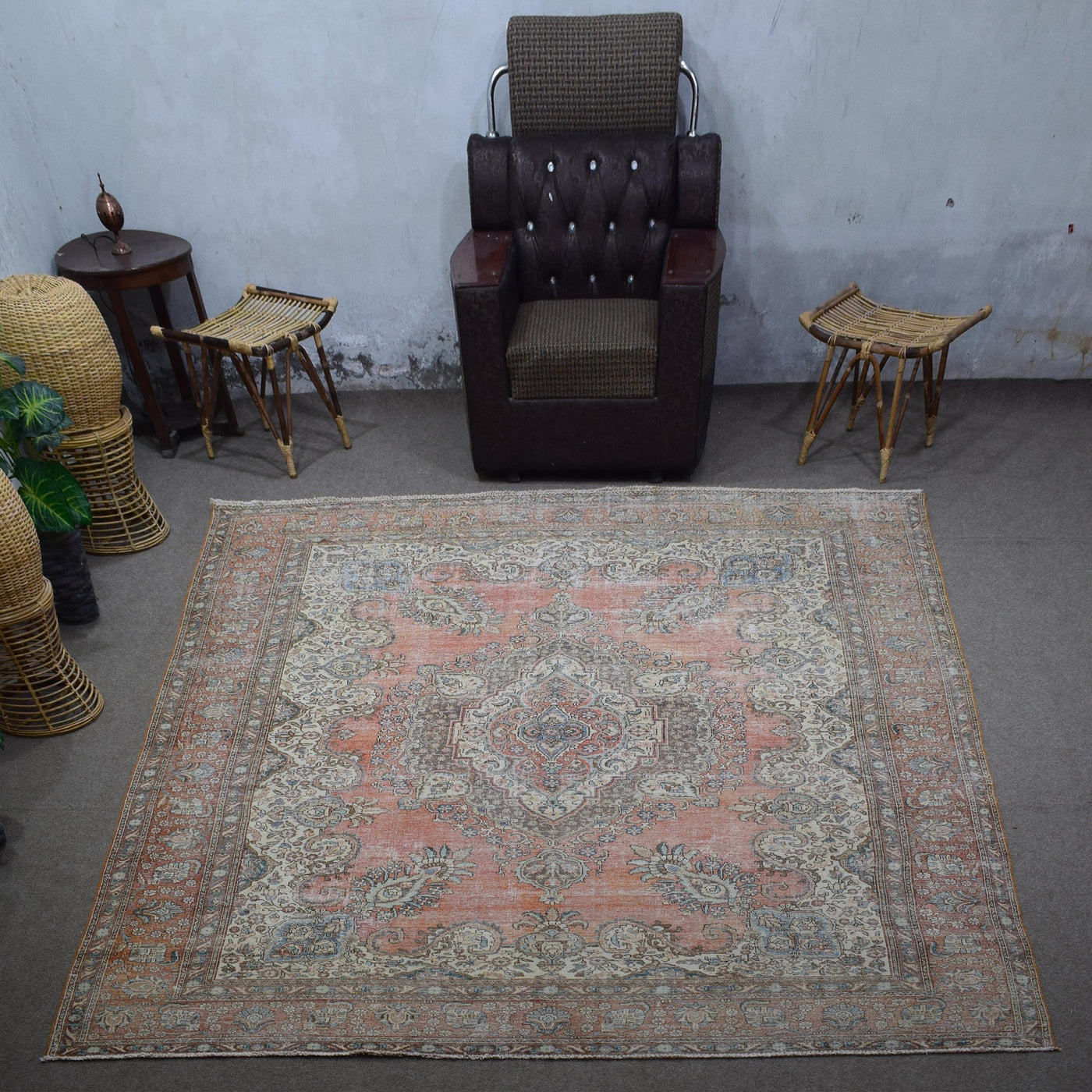Large distressed vintage Persian rug 282x395 cm styled in interior showing worn terracotta tones and ornate medallion