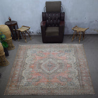 Large distressed vintage Persian rug 282x395 cm styled in interior showing worn terracotta tones and ornate medallion