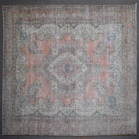 Close up of Persian rug border with traditional floral motifs in soft blue and ivory tones