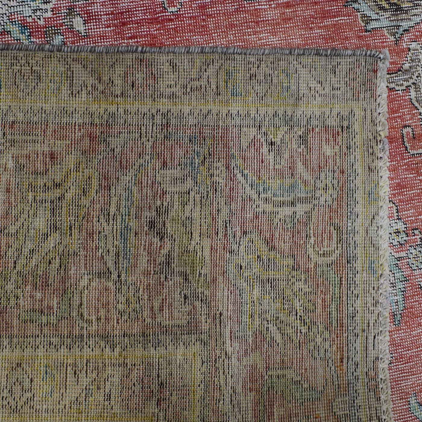 Backside of hand knotted Persian rug showing weave structure and authentic handmade construction