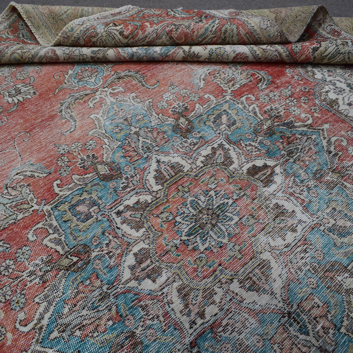 Macro detail of vintage Persian rug medallion highlighting intricate floral elements and wool texture