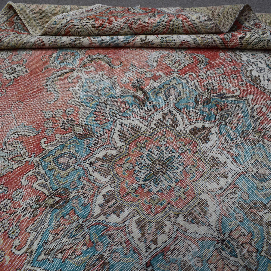 Macro detail of vintage Persian rug medallion highlighting intricate floral elements and wool texture