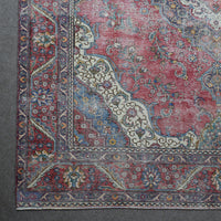 Corner detail of Persian rug with decorative floral border and traditional Persian motifs