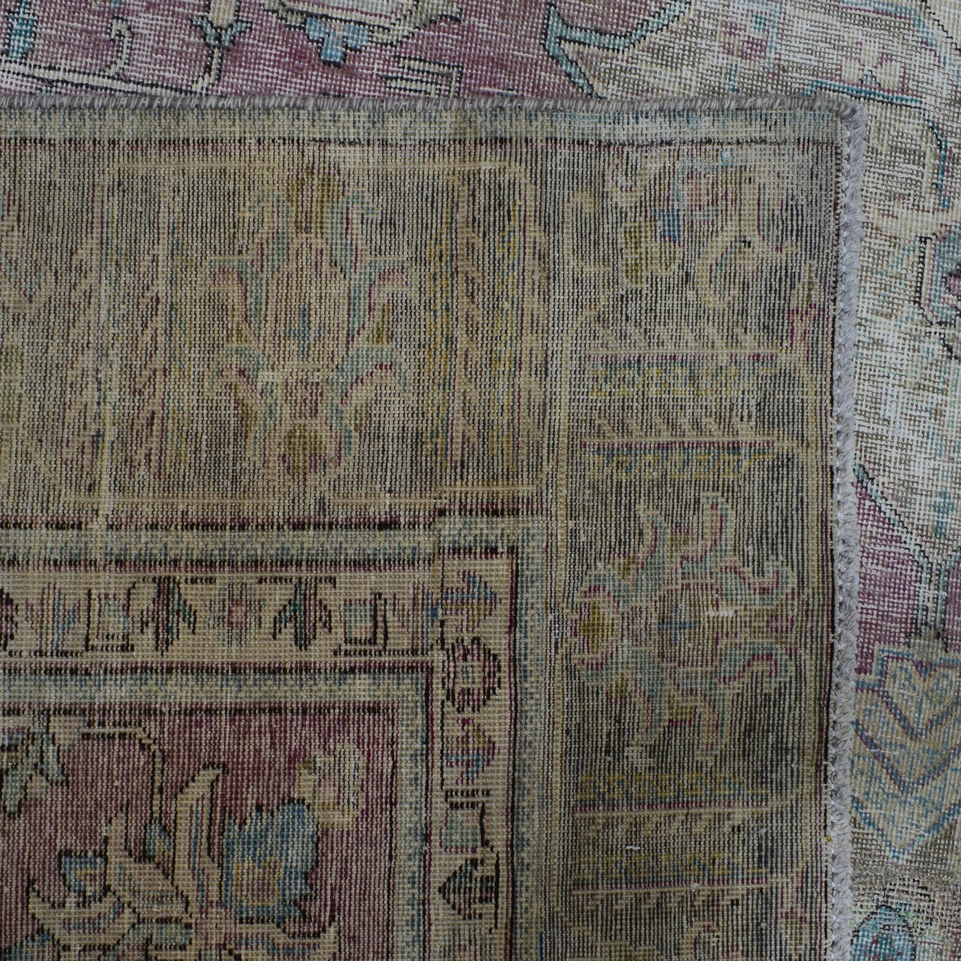 Backside of hand knotted Persian rug showing weave structure and authentic handmade construction