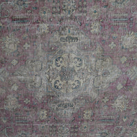 Detailed view of vintage Persian rug medallion featuring soft ivory and blue floral elements