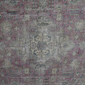 Detailed view of vintage Persian rug medallion featuring soft ivory and blue floral elements