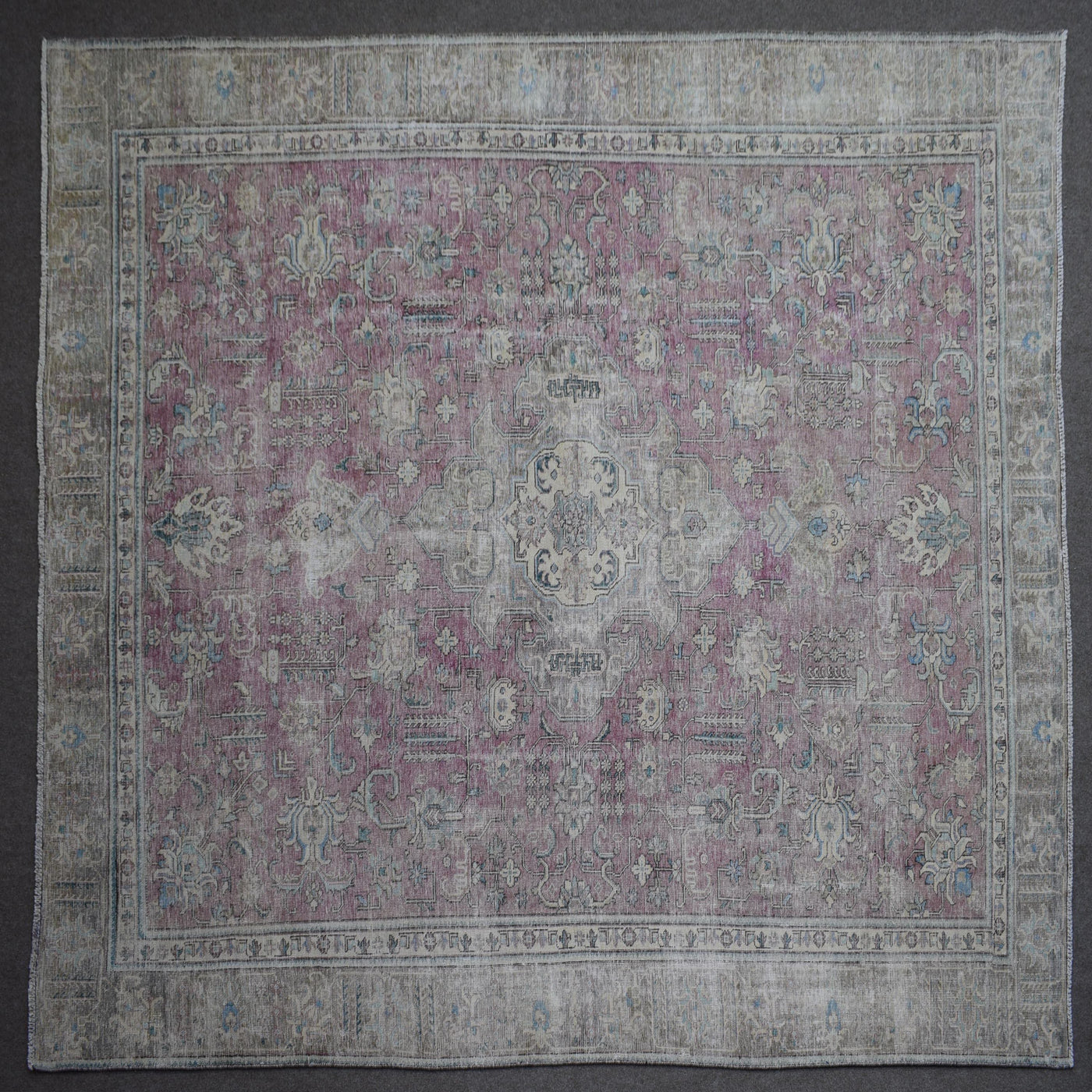 Close up of Persian rug border with traditional floral motifs and ivory guard stripes
