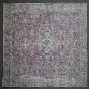 Close up of Persian rug border with traditional floral motifs and ivory guard stripes
