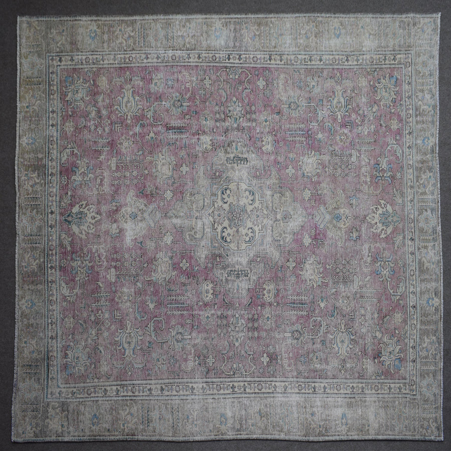 Close up of Persian rug border with traditional floral motifs and ivory guard stripes