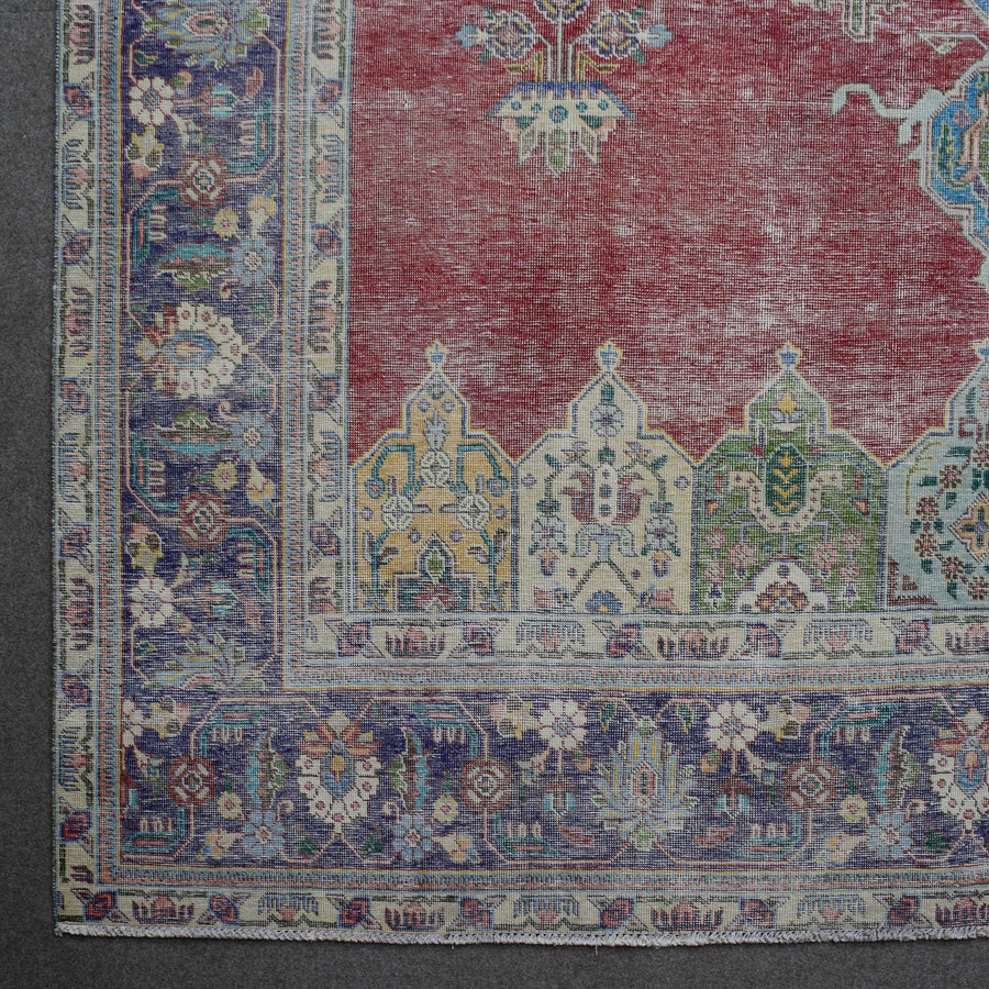 Corner detail of Persian rug with decorative border and colorful traditional motifs