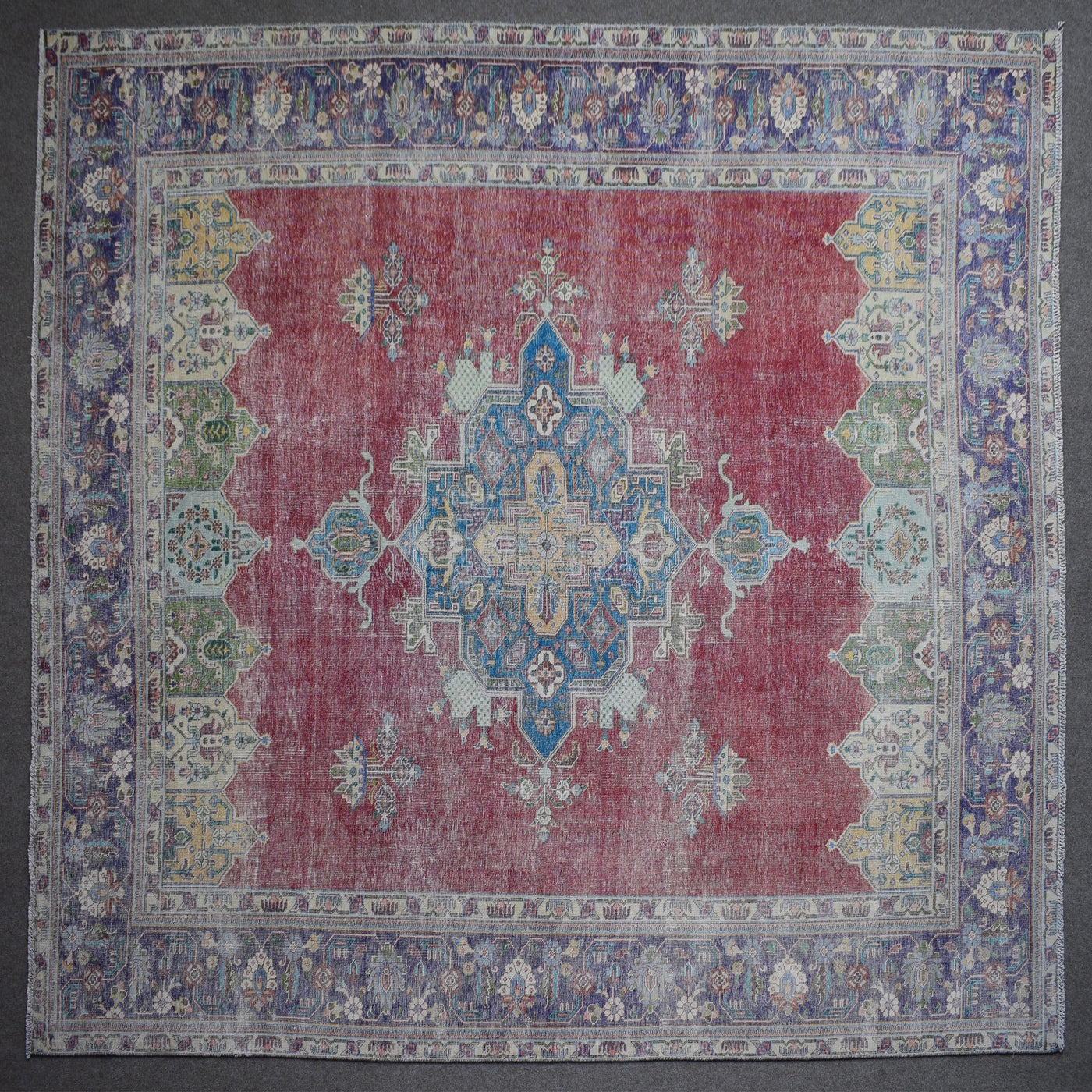 Close up of Persian rug border with colorful floral motifs and intricate guard stripes
