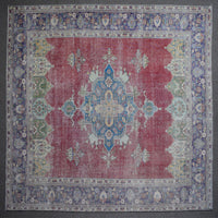 Close up of Persian rug border with colorful floral motifs and intricate guard stripes