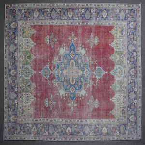 Close up of Persian rug border with colorful floral motifs and intricate guard stripes
