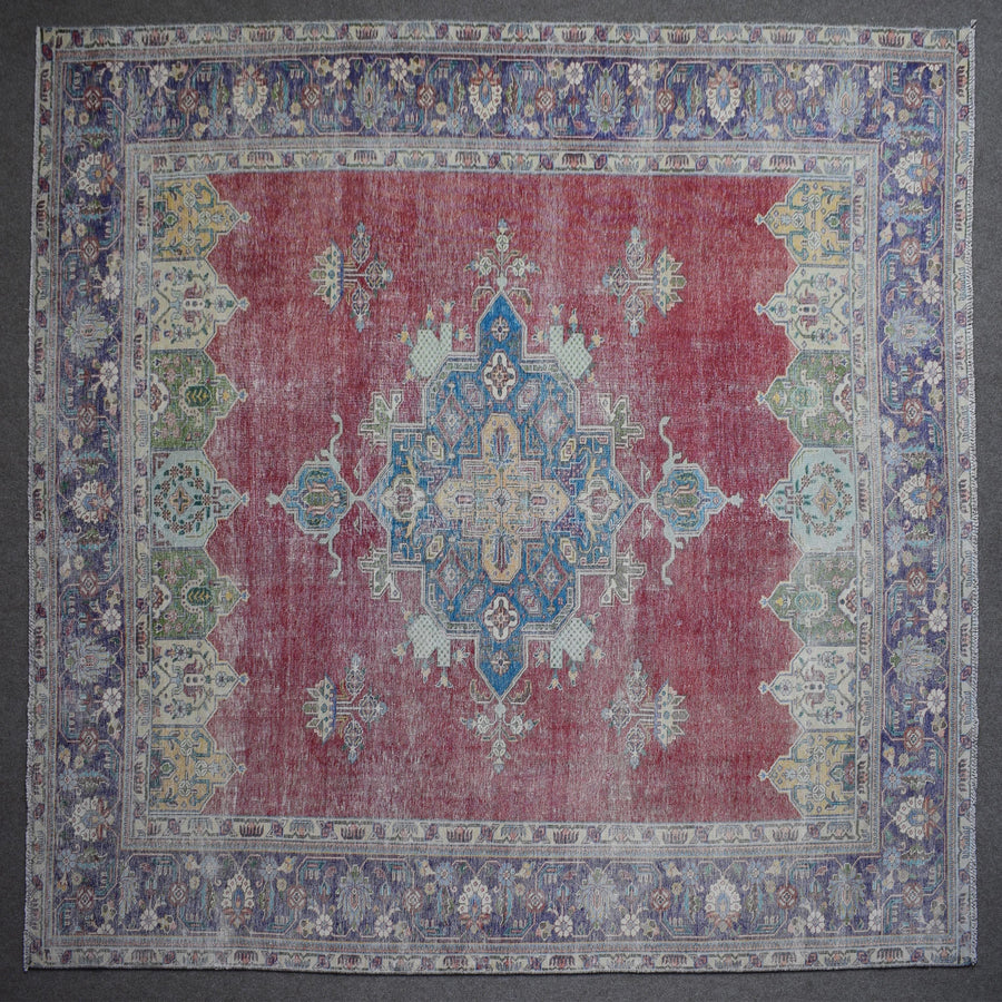 Close up of Persian rug border with colorful floral motifs and intricate guard stripes