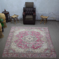 Large distressed vintage Persian rug 272x366 cm styled in interior showing worn rose tones and traditional Persian design