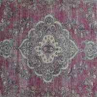 Detailed view of vintage Persian rug medallion featuring ivory and blue floral motifs
