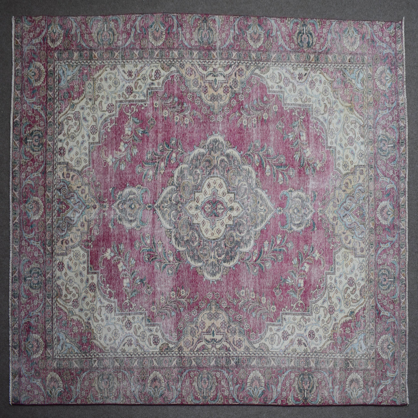 Close up of Persian rug border with traditional floral motifs and intricate guard stripes