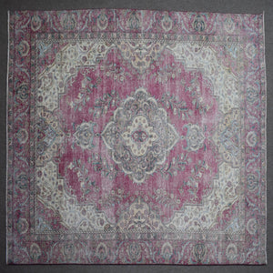 Close up of Persian rug border with traditional floral motifs and intricate guard stripes