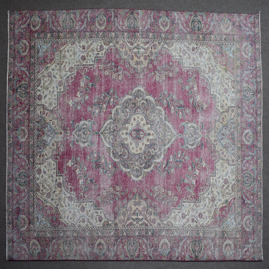 Close up of Persian rug border with traditional floral motifs and intricate guard stripes