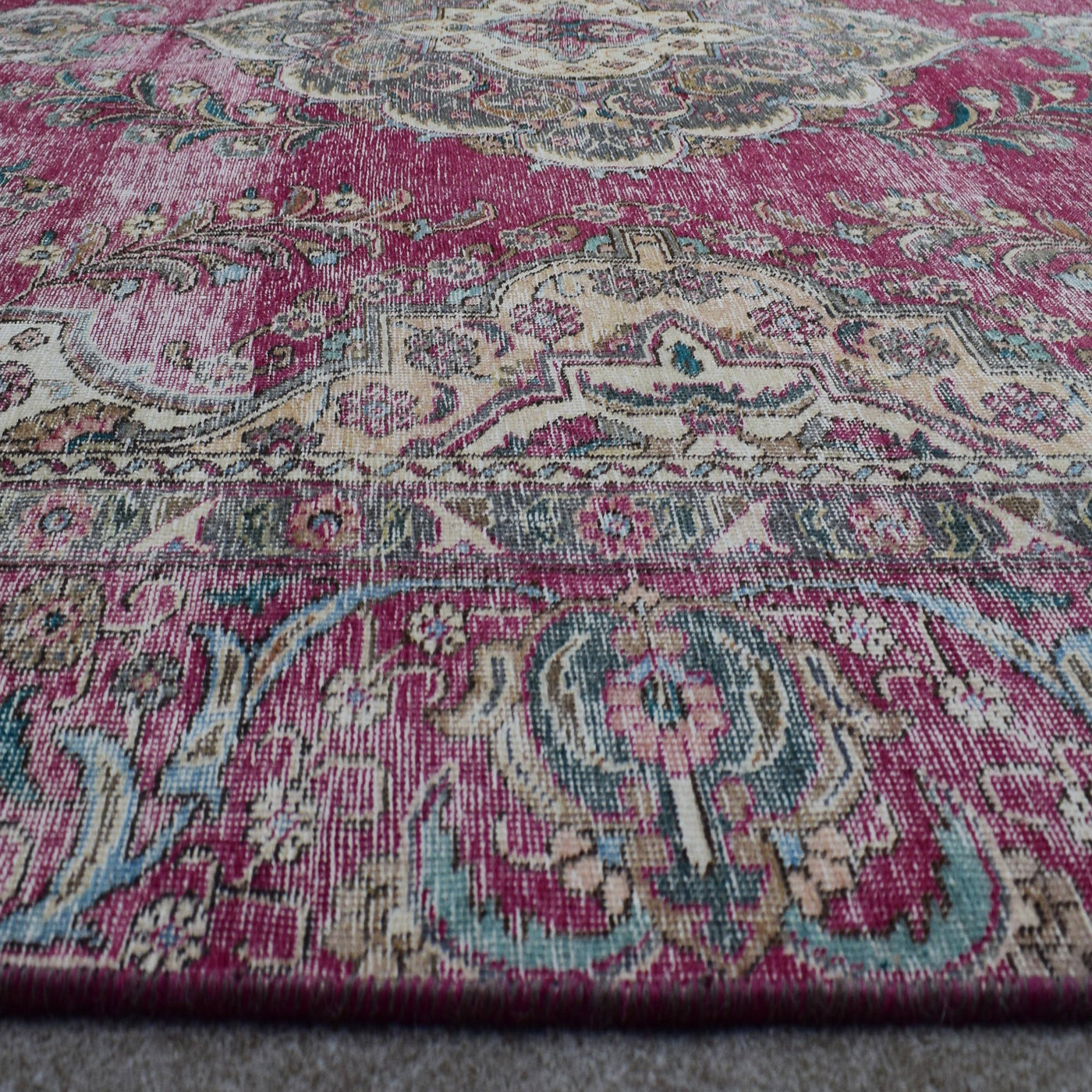 Macro close up of Persian rug medallion highlighting detailed floral elements and wool texture