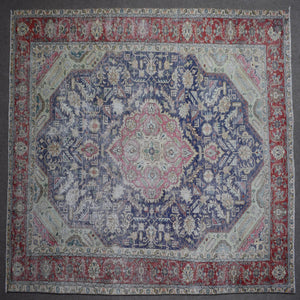 Close up of Persian rug border with colorful floral motifs and intricate guard stripes