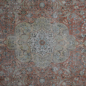 Detailed view of vintage Persian rug medallion featuring ivory and blue floral motifs