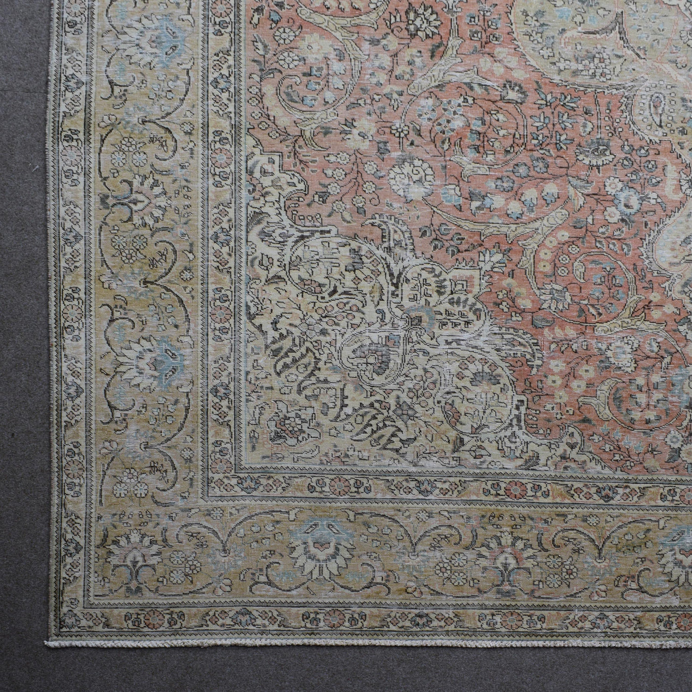 Corner detail of Persian rug with decorative floral border and traditional Persian design
