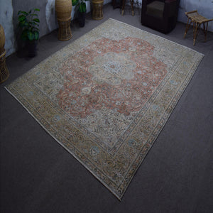 Hand knotted Persian rug photographed at an angle showing overall medallion layout and distressed vintage palette