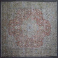Close up of Persian rug border with floral motifs and intricate guard stripes in soft beige and coral tones