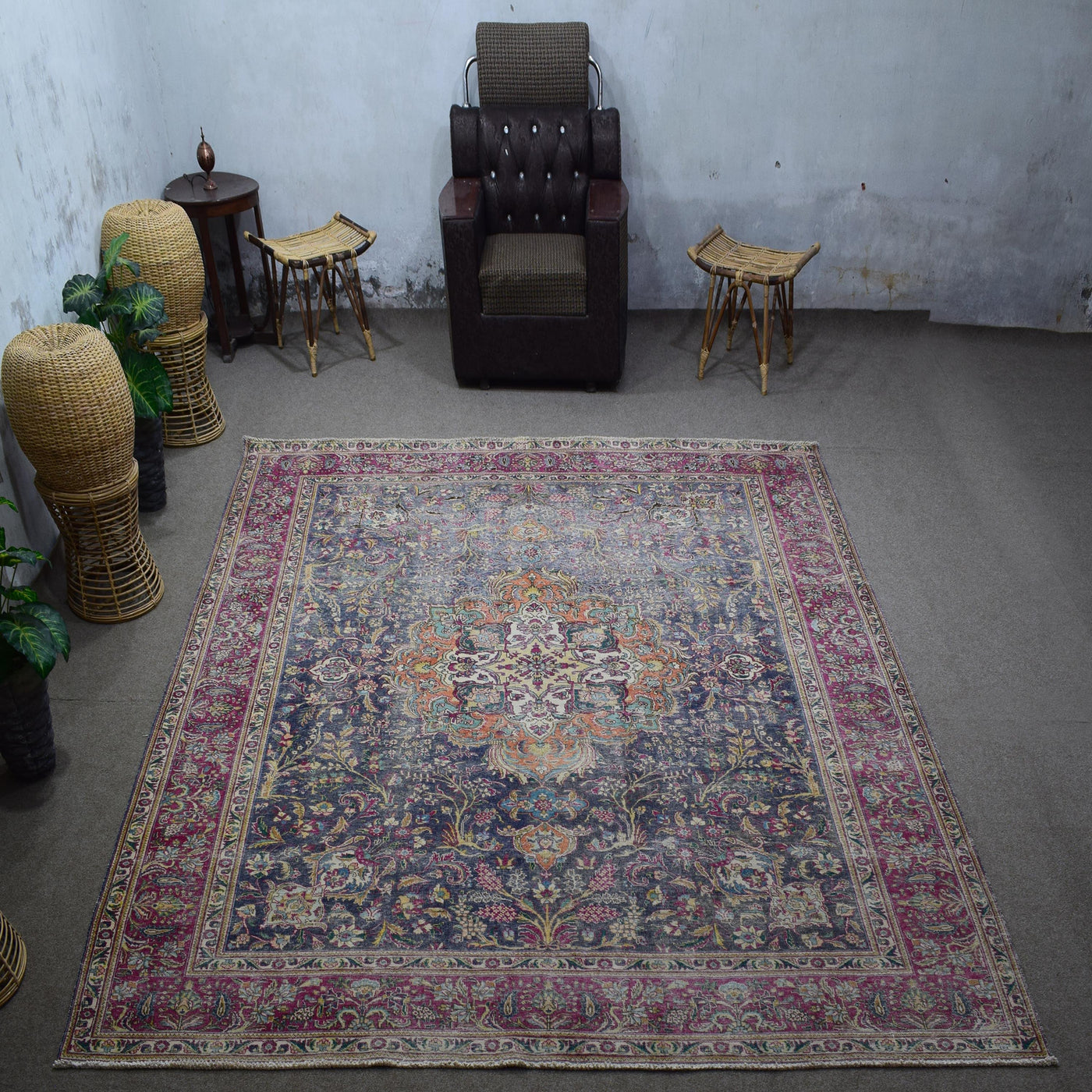 Large distressed vintage Persian rug 295x366 cm styled in interior showing deep navy background and intricate medallion design