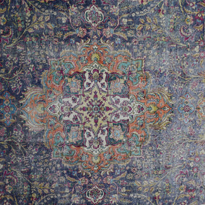 Detailed view of vintage Persian rug medallion featuring colorful floral motifs on dark navy field