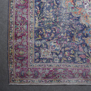 Corner detail of Persian rug with decorative floral border and traditional Persian motifs