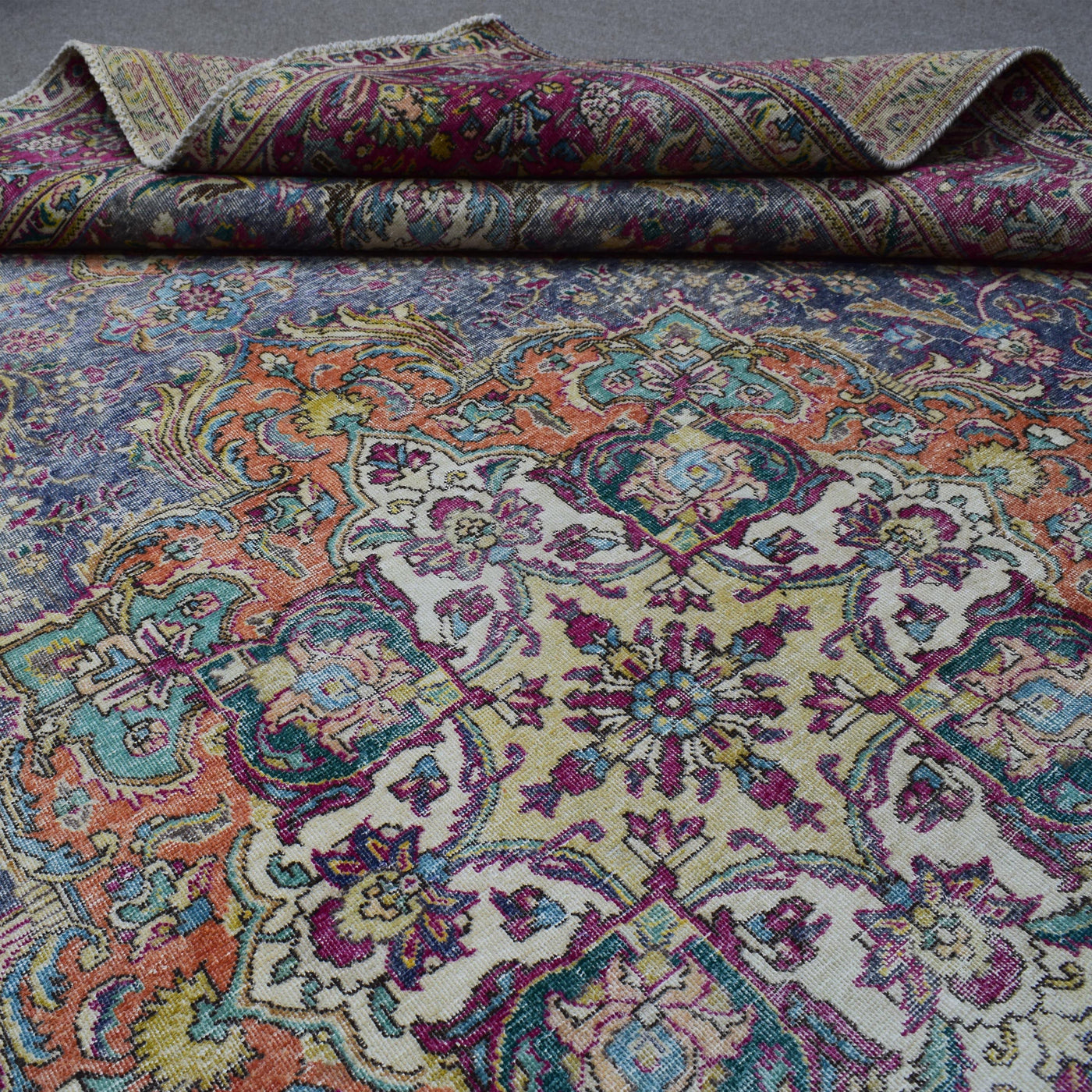 Macro detail of Persian rug medallion highlighting dense floral patterns and wool texture
