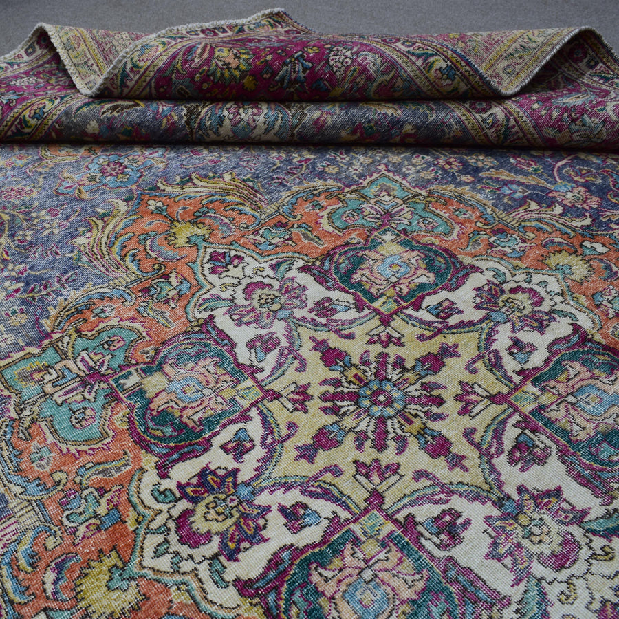 Macro detail of Persian rug medallion highlighting dense floral patterns and wool texture