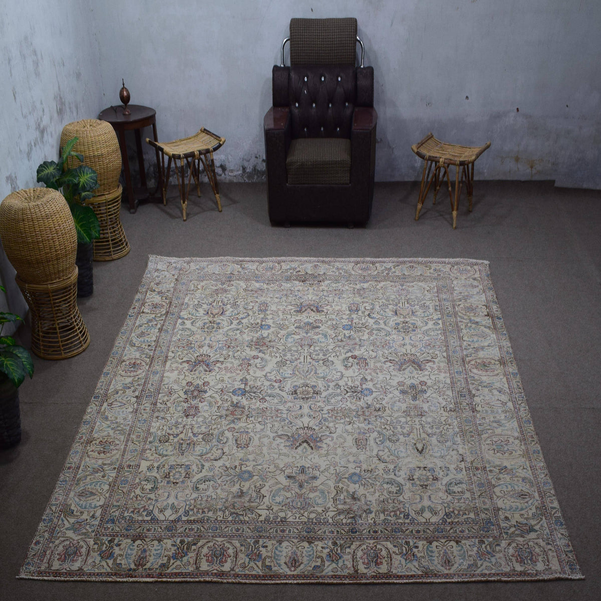 Large distressed vintage Persian rug 285x348 cm styled in interior showing soft ivory tones and delicate floral pattern