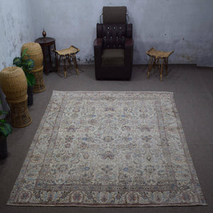 Large distressed vintage Persian rug 285x348 cm styled in interior showing soft ivory tones and delicate floral pattern