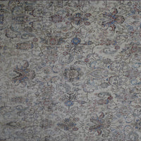 Detailed view of vintage Persian rug pattern featuring traditional Persian floral design in soft blue and beige tones