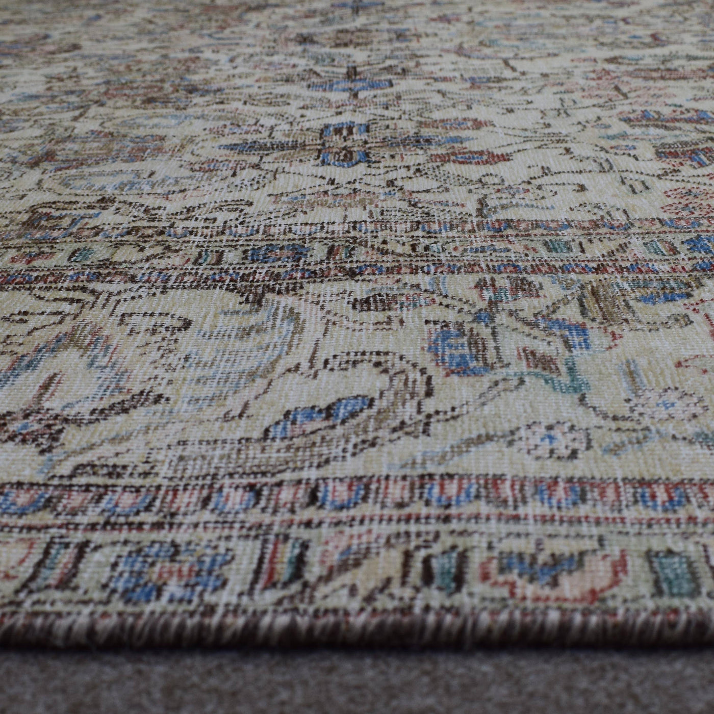 Macro close up of Persian rug pile showing wool texture and worn vintage surface