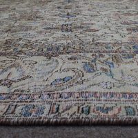 Macro close up of Persian rug pile showing wool texture and worn vintage surface
