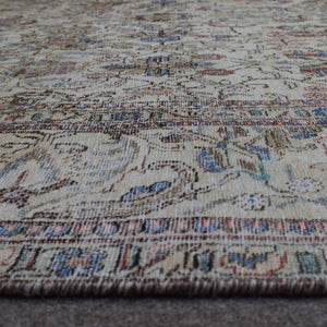 Macro close up of Persian rug pile showing wool texture and worn vintage surface