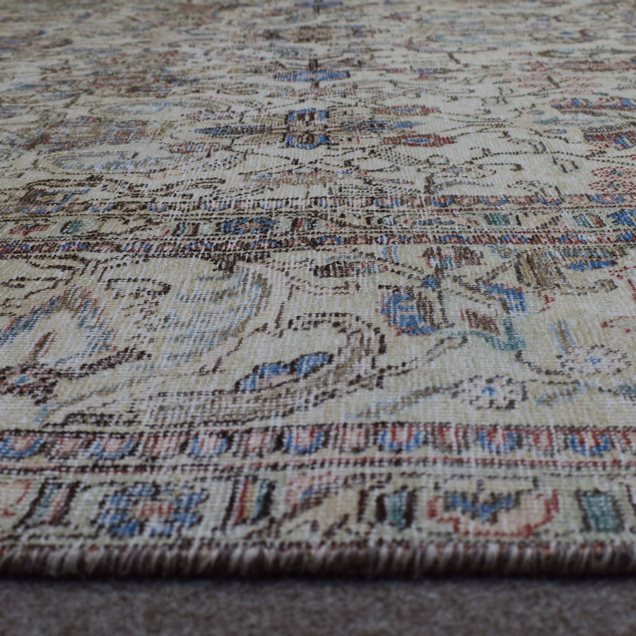 Macro close up of Persian rug pile showing wool texture and worn vintage surface