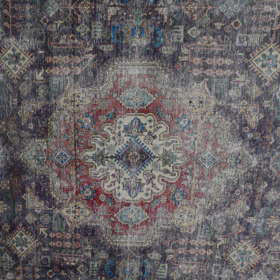 Detailed view of vintage Persian rug medallion featuring traditional Persian floral patterns