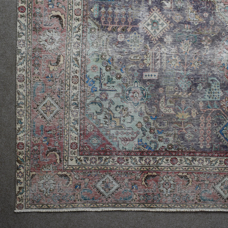 Corner detail of Persian rug with decorative border and traditional geometric motifs