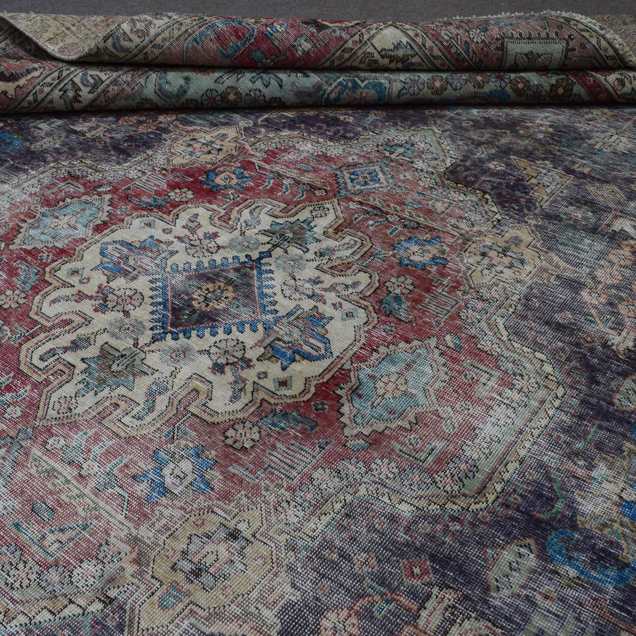 Macro detail of Persian rug medallion highlighting dense floral elements and wool texture